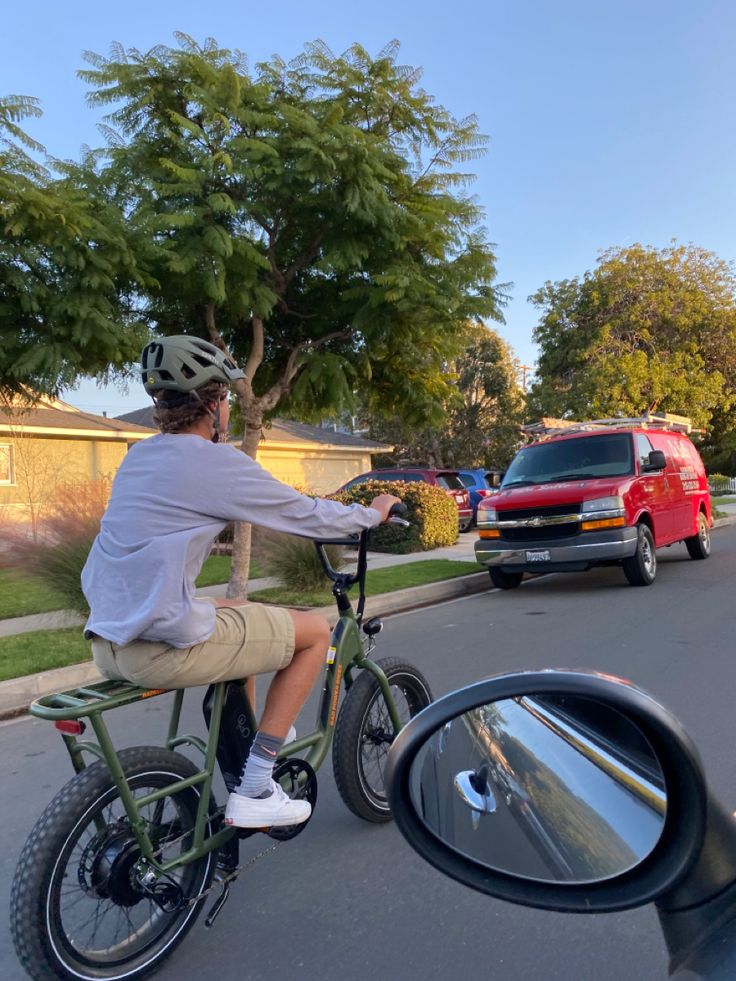 a person riding a bike down the street