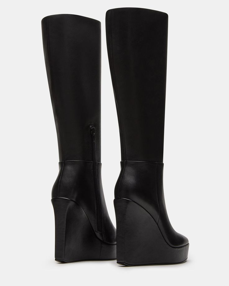 The AKIRA knee-high boot features a platform wedge design and a convenient inside zipper for easy on and off. Elevate your style game with this versatile and stylish boot, perfect for any occasion. 4.5 inch heel height Size 6 measurements: 14 inch shaft circumference, 13.75 inch shaft height Size 8 measurements: 15 inch shaft circumference, 14.75 inch shaft height Size 10 measurements: 16 inch shaft circumference, 15.75 inch shaft height Leather upper material Textile lining Synthetic sock Synth Chic Knee-high Chunky Platform Boots, Trendy High Shaft Leather Platform Boots, High Heel Polyurethane Platform Boots With Zipper, High Heel Platform Boots With Zipper Closure, Chic Knee-high Boots With Chunky Platform, Chic Faux Leather Platform Boots With Zipper, Black High Shaft Platform Boots, Modern Knee-high Platform Heeled Boots, Black High Cut Leather Knee-high Boots