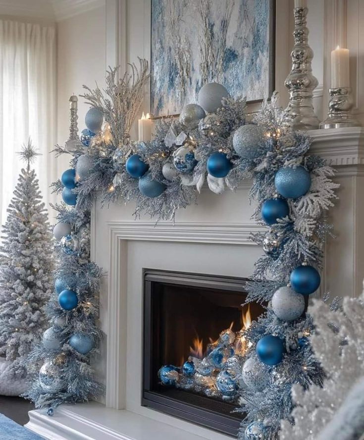 a fireplace decorated with blue and silver ornaments