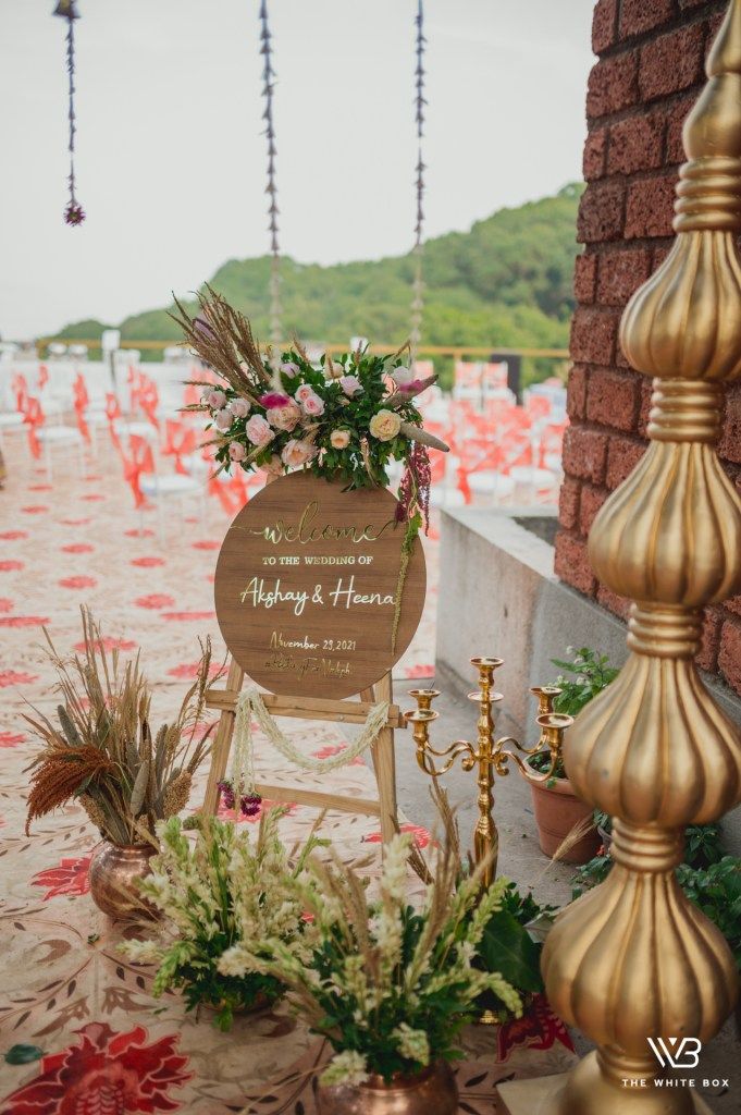 a wooden sign sitting on top of a table covered in flowers