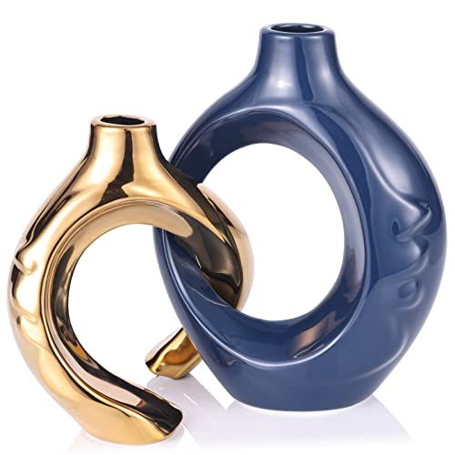 two gold and blue vases sitting next to each other