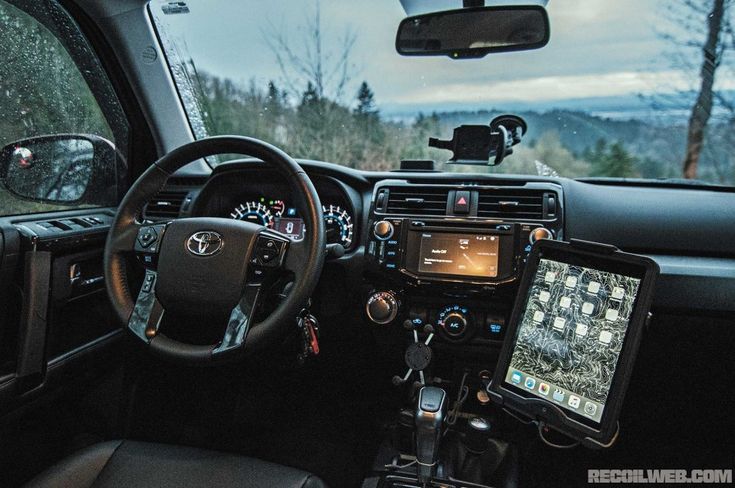 the interior of a vehicle with dashboard, steering wheel and gps