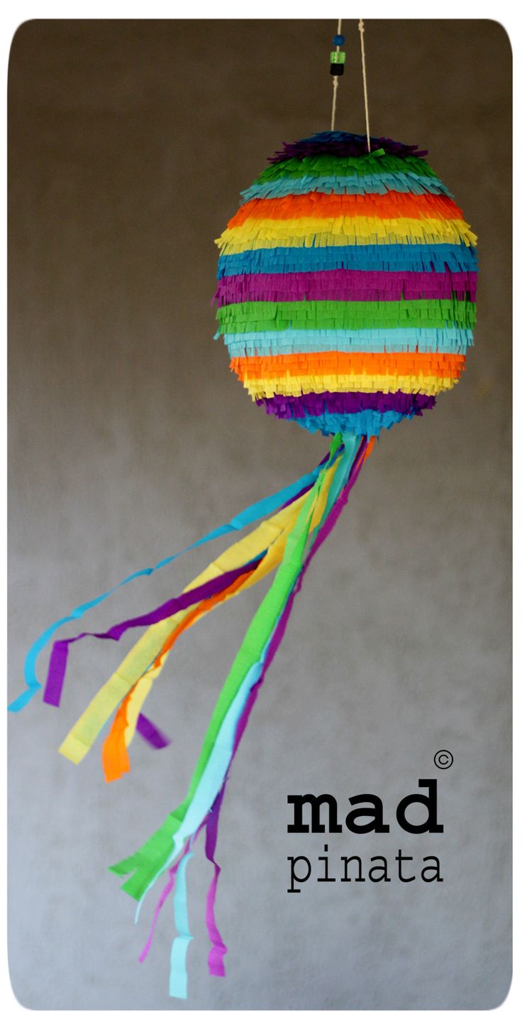 a multicolored pinata hanging from a string on a hook with the word mad pinata below it