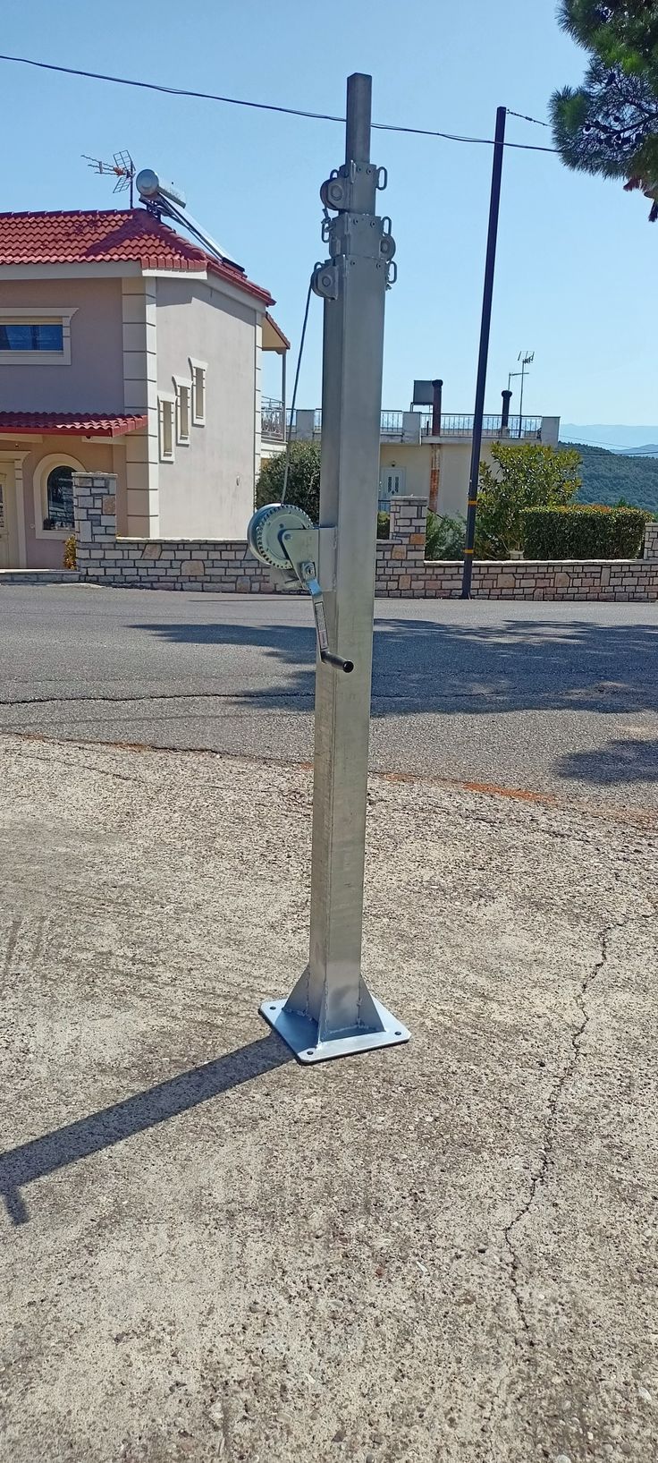 there is a metal pole on the side of the road