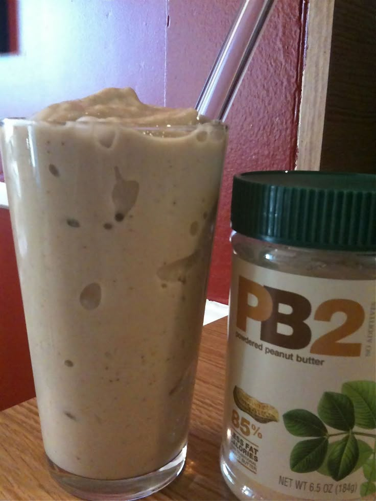 a jar of peanut butter next to a drink