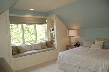 a bed sitting under a window in a bedroom