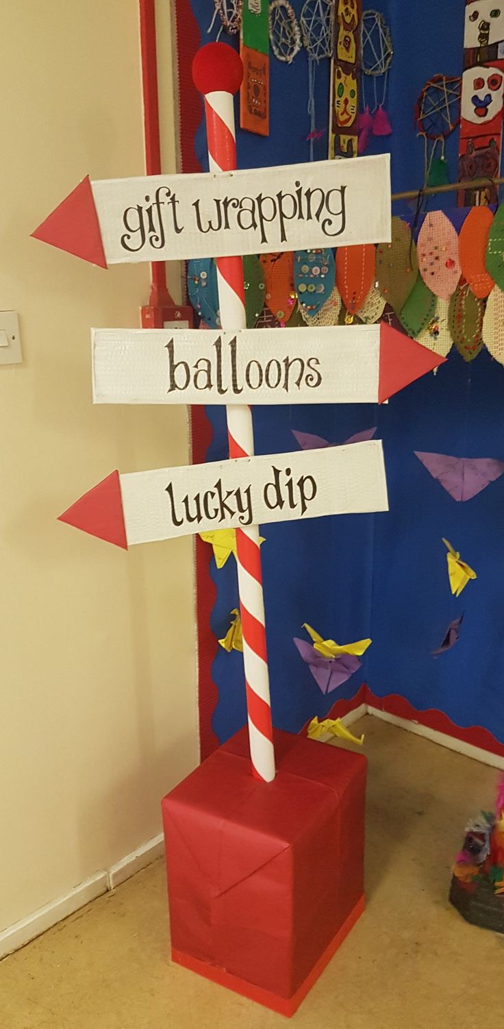 a sign that says gift wrapping, balloons, lucky dip and paper birds on it