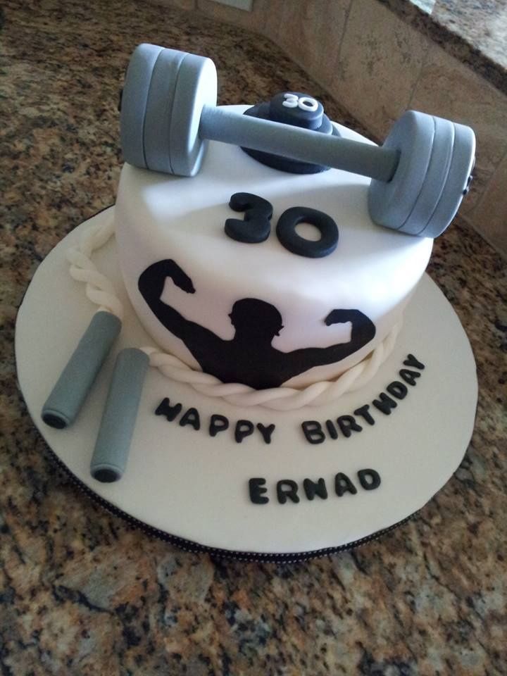 a birthday cake with a weight and dumbs on it