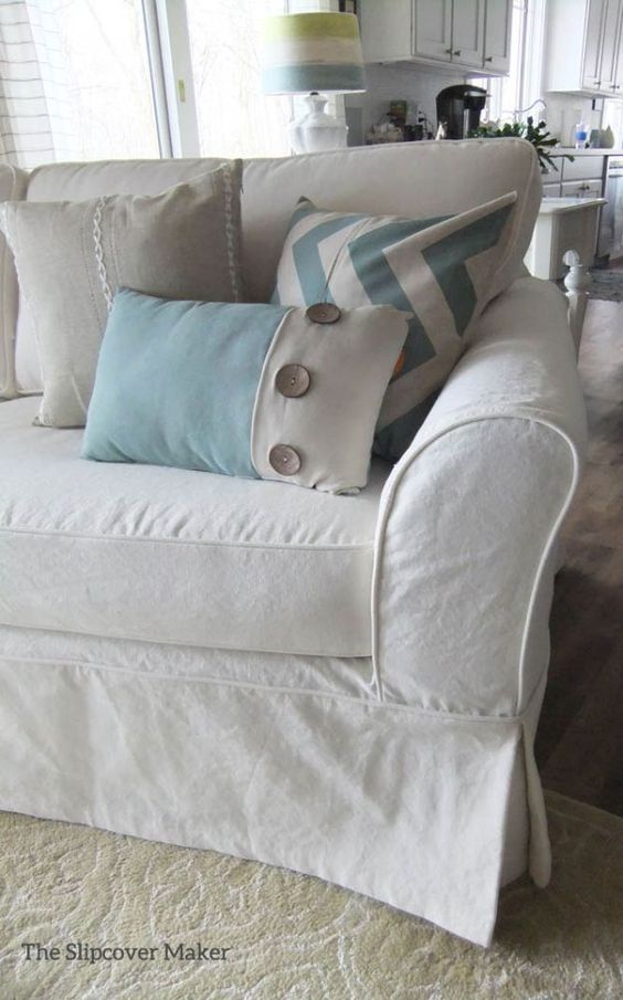 a white couch with several pillows on it