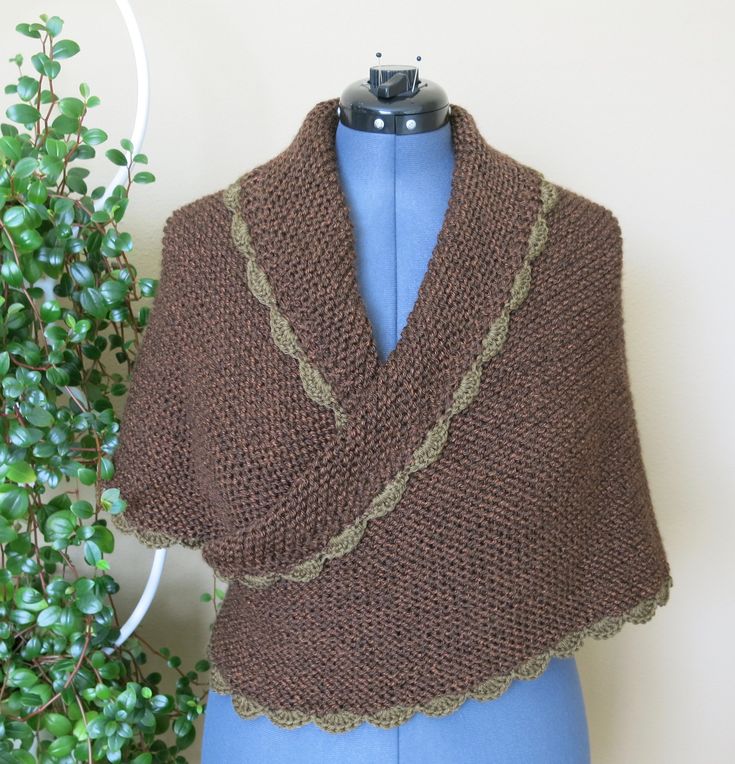 A 100% soft premium acrylic hand-knit triangle shawl, inspired by Claire's shawl in Outlander Season 5, Episodes 8 and 11. It is sequoia brown, and olive crochet on the edge of the shawl. It is perfect for size M, and will work for size S and L, with a different look. (The pictures are taken on an L size mannequin.) It is very cozy, and can be tied in back to fit better. The wrap measures 66 inches tip to tip, 33 inches from center back top to bottom tip, plus a 16 inch cord. It weighs 16 ounces Katniss Shawl, Knit Triangle, Triangle Shawl, Triangle Shawls, Happy Valley, On The Edge, Knit Scarf, Outlander, Clothing Items