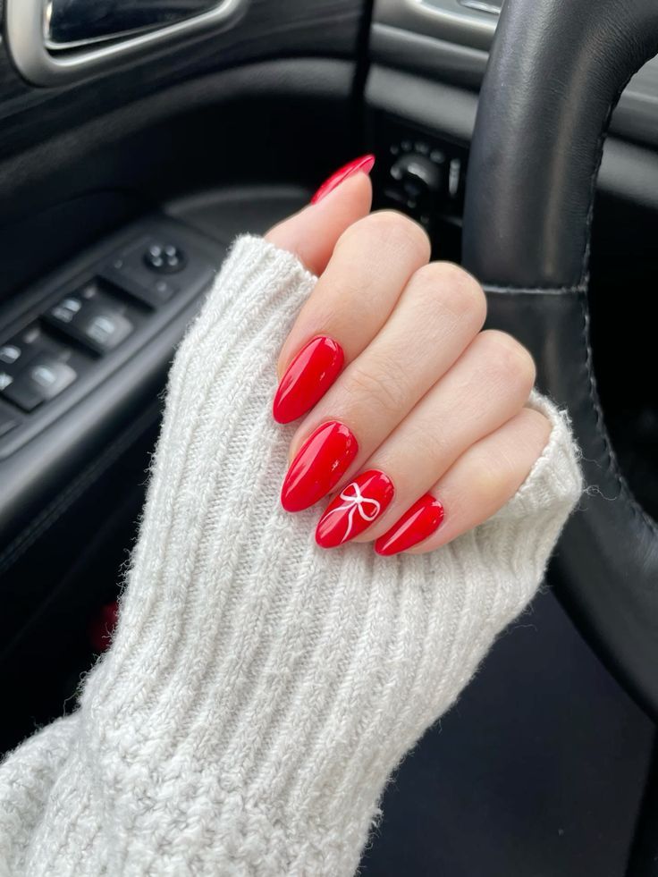 Nails Christmas Bow Design, Christmas Nails Red And White Bow, Christmas Nails Red Almond Shape, Red Bow Holiday Nails, Red Almond Nails With Bow, Nails Bow Christmas, Almond Nails Designs Bow, Red Nails With Christmas Design, Christmas Acrylic Almond Nails