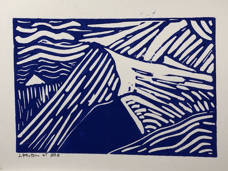 a blue and white linoleum print with mountains in the background