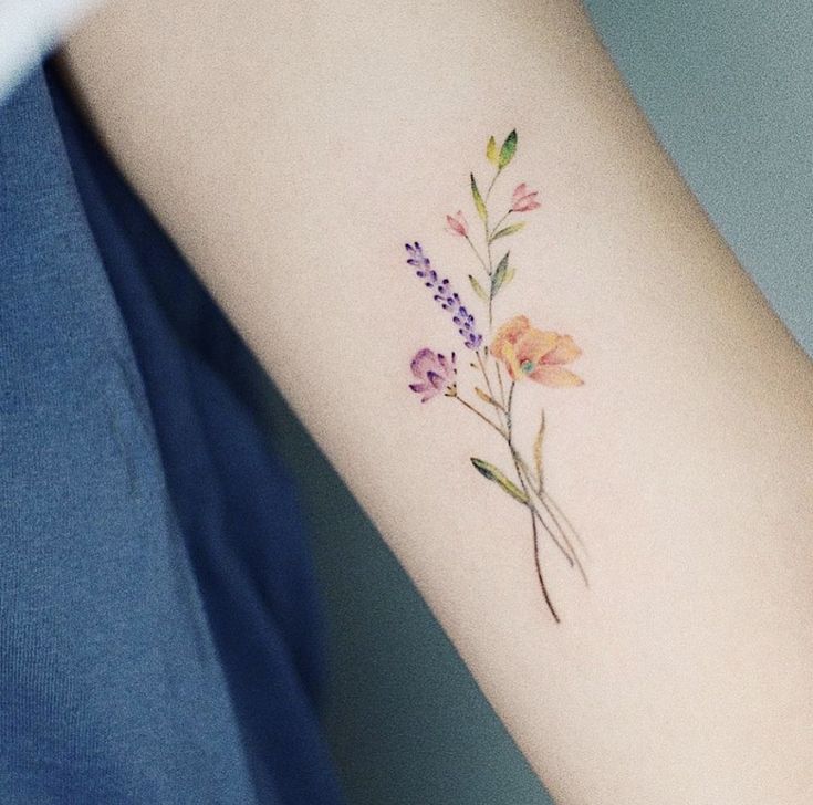 a woman's arm with flowers on it