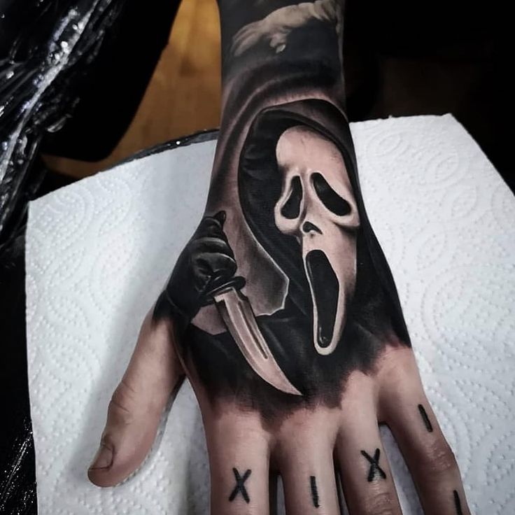 a person's hand with a tattoo on it