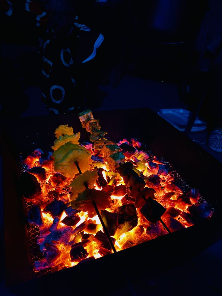 the grill is full of hot dogs and marshmallows