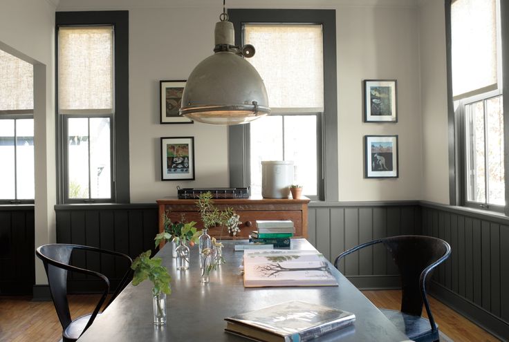 the dining room table is set with books and vases