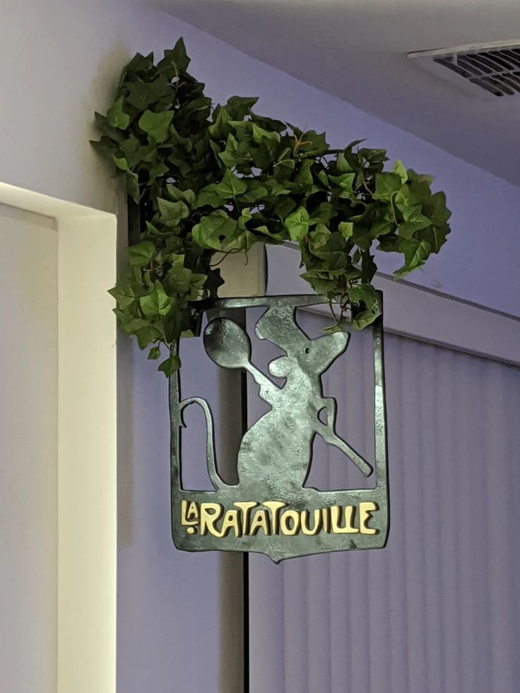 a metal sign that says ratatoulie hanging from the side of a wall