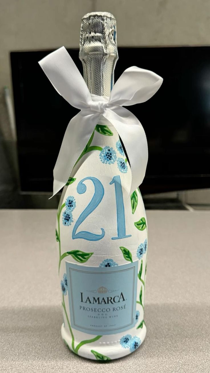 a bottle that is sitting on a table with a ribbon around it's neck