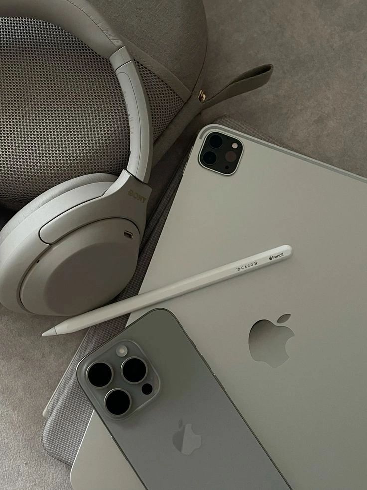 an iphone and headphones are laying on the floor next to each other with one earbud