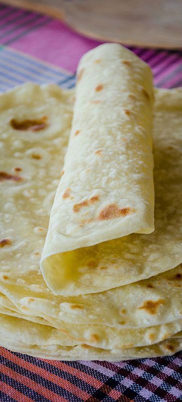 some tortillas are stacked on top of each other