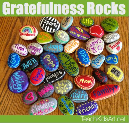 rocks with the words gratefulness rocks written on them in different colors and sizes, sitting on a wooden table