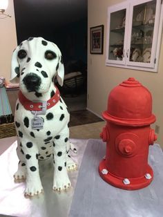 a dalmatian dog statue next to a fire hydrant in the living room