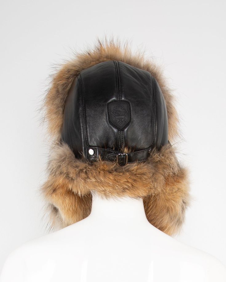 Embrace the season’s charm with this statement-making fur-trimmed trapper hat, a perfect blend of rustic appeal and sophisticated warmth. Crafted from supple buffed lambskin leather, this luxurious piece is encircled with fine, real fur that adds a touch of opulence to every edge. But beyond its high-fashion finish, this cap is built to withstand winter’s harshest elements. Whether you’re navigating city streets or conquering the slopes, the fur-lined earflaps ensure you stay comfortably insulat Luxury Winter Hats With Faux Fur Lining, Luxury Winter Hat With Faux Fur Lining, Trapper Hat, Trapper Hats, Big City, Polyester Satin, Real Fur, City Streets, Lambskin Leather