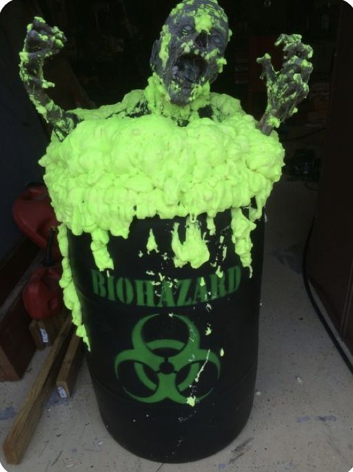 a trash can covered in green and black paint