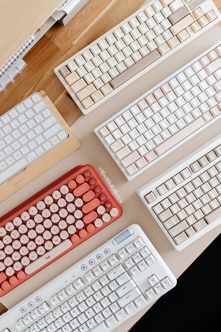 there are many different keyboards on the table with each one's key board attached to it