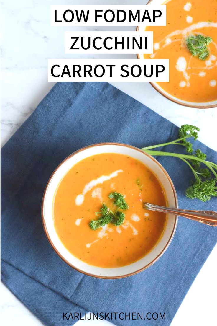 low fodmap zucchini carrot soup in two bowls on a blue napkin