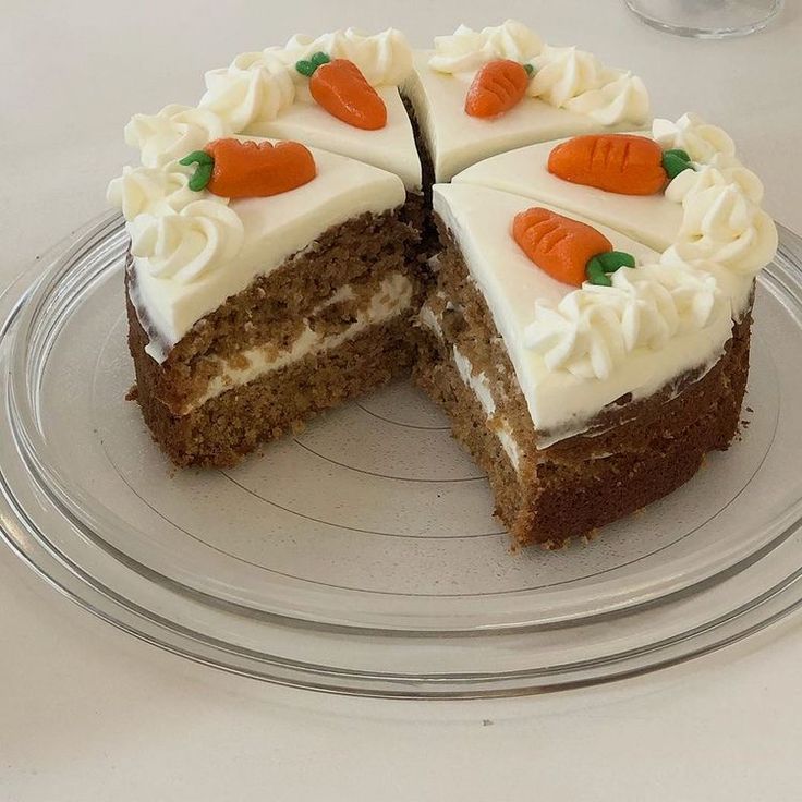 a carrot cake with white frosting on a plate