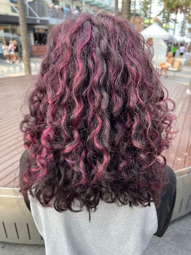 Magenta Highlights Curly Hair, Curly Skunk Highlights, Purple Highlights In Brown Hair Curly, Peak A Boo Highlights Curly Hair, Brunette Curly Hair Balayage, Purple Peekaboo Highlights Curly Hair, Chunky Pink Highlights Curly Hair, Curly Draculaura Hair, Brown Hair Pink Highlights Curly