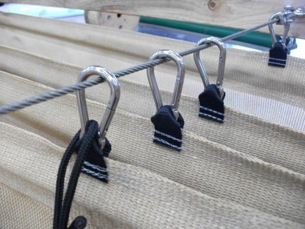 three metal hooks are attached to the side of a sailboat