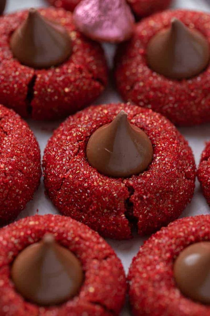 some red cookies with chocolate hearts on them