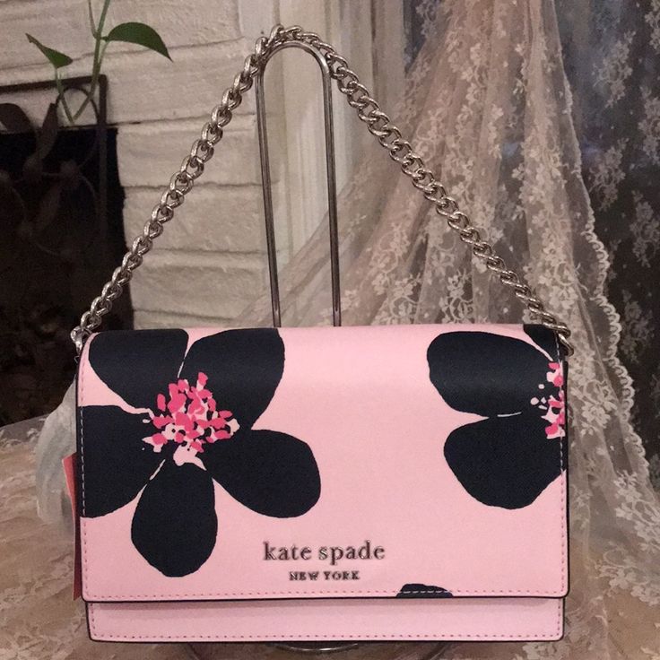 New With Tags Kate Spade Cameron Grand Flora Crossbody Bag Color-Pink With Black Flowers 5.8"H X 9.2"W X 2.6” Drop: 22" Material : Saffiao Two Way Spade Jacquard Lining Metal Pinmount Logo Flap And Magnetic Snap Closure Interior Back Slip Pockets Exterior Back Slip Pocket Pet-Free & Smoke-Free House Spring Pink Bag With Chain Strap, Pink Spring Bags With Chain Strap, Spring Pink Bags With Chain Strap, Pink Chain Strap Bag For Spring, Kate Spade Pink Crossbody Shoulder Bag, Feminine Pink Kate Spade Bag, Kate Spade Pink Pouch Bag, Kate Spade Pink Rectangular Bag, Kate Spade Black Spring Bag