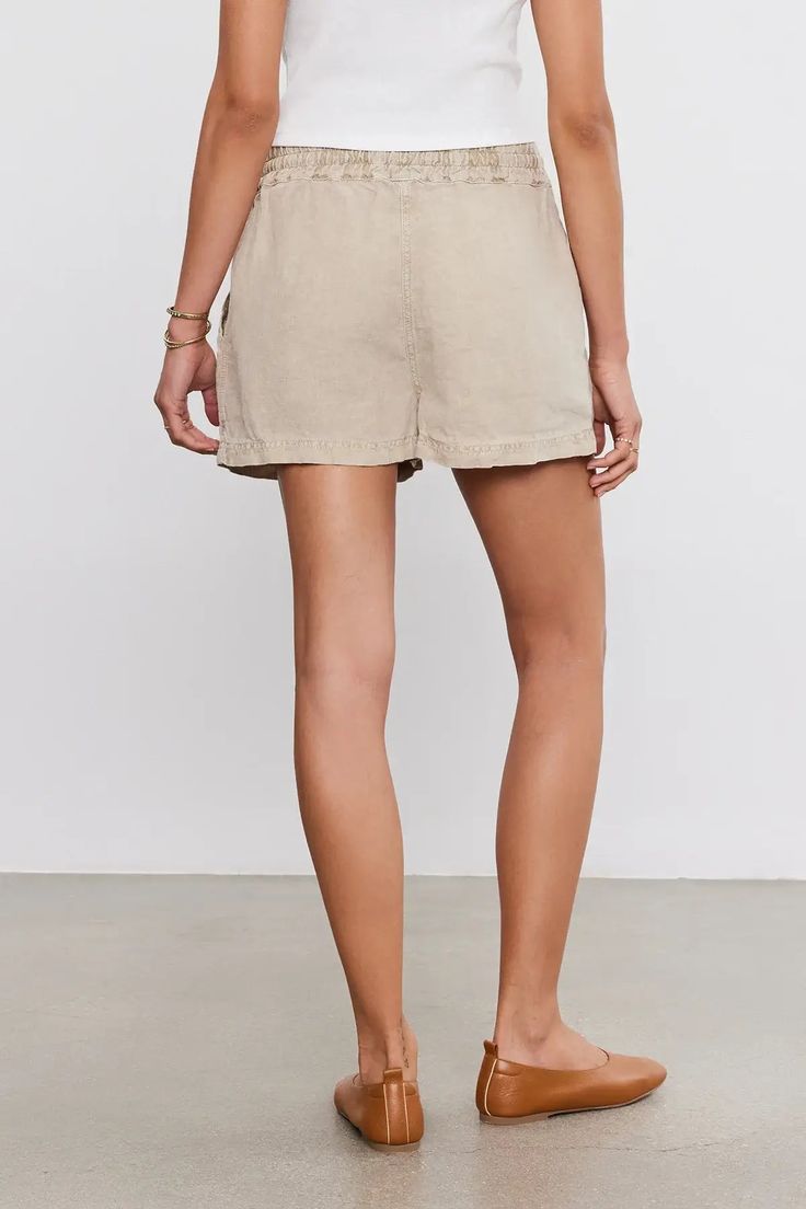 Made from a mid-weight linen that strikes the perfect balance between comfort and durability. With its relaxed fit and elastic drawstring waist, these shorts are ideal for relaxing days or beachside adventures. Complete with slash patch pockets for added convenience, they're the ultimate warm-weather essential. Linen Bermuda Shorts With Built-in Shorts And Relaxed Fit, Relaxed Cotton Shorts For Beach Season, Solid Color Summer Shorts With Relaxed Fit, Summer Cargo Shorts With Drawstring, Summer Drawstring Cargo Shorts, Casual Bermuda Shorts For Beach With Short Inseam, Casual Pull-on Bermuda Shorts, Spring Beach Cargo Shorts In Cotton, Relaxed Summer Bottoms With Pull-on Style