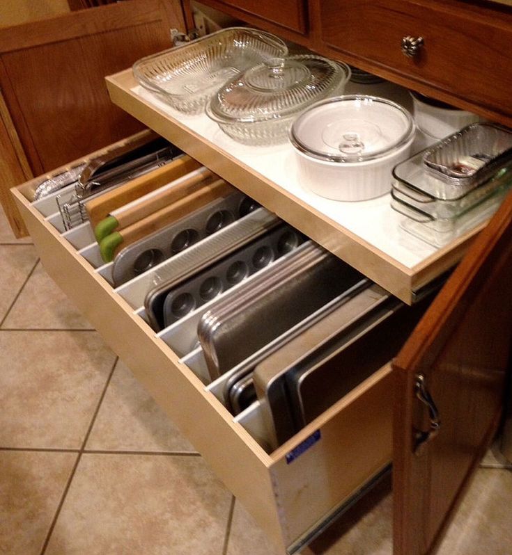 an open drawer in a kitchen filled with utensils