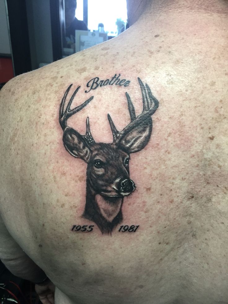 the back of a man's shoulder with a deer head and name on it