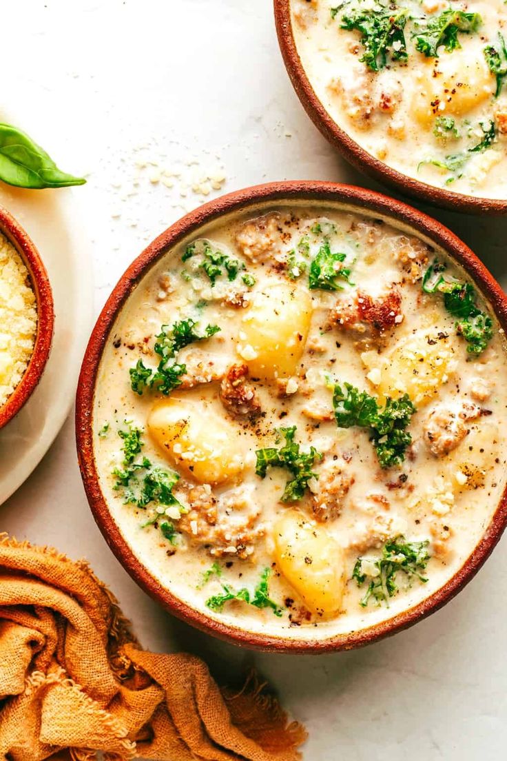 three bowls filled with food on top of a table