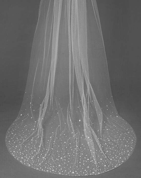 a white veil on top of a table with flowers in the center and sparkles all over it