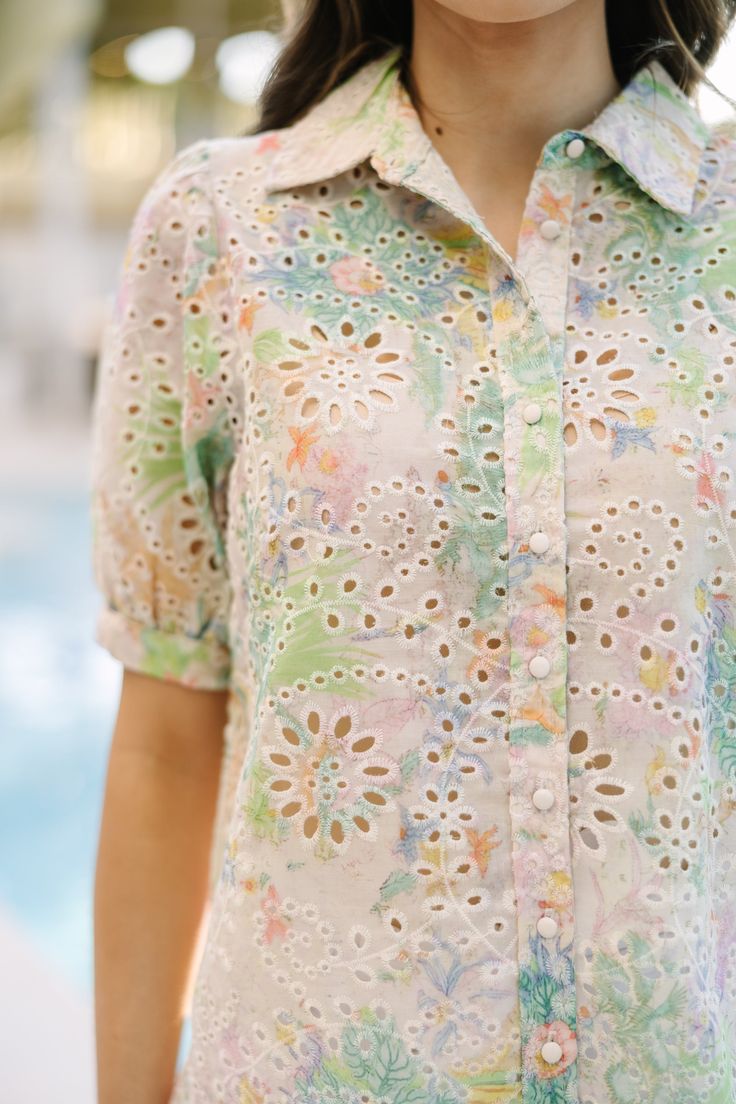 Just take a look at this adorable blouse! That eyelet fabric is already perfect for the warmer weather. But then you throw in that light tie dye coloring and it really takes this beauty to the next level! Collared neckline Button down front closure Short puff sleeves Eyelet fabric Light tie dye print No stretch Savannah is wearing the small. Spring Eyelet Button-up Top, Spring Collared Blouse With Broderie Anglaise, Summer Patterned Blouse With Button Closure, Spring Tie Dye Tops, Tie Dye Floral Print Summer Top, Summer Floral Print Tie Dye Top, Tie Dye Floral Print Top For Summer, Spring Button-up Blouse With Broderie Anglaise, Summer Collared Broderie Anglaise Tops