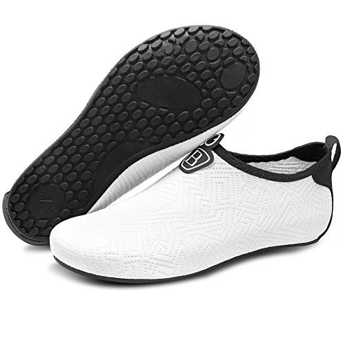 a pair of white shoes with black soles