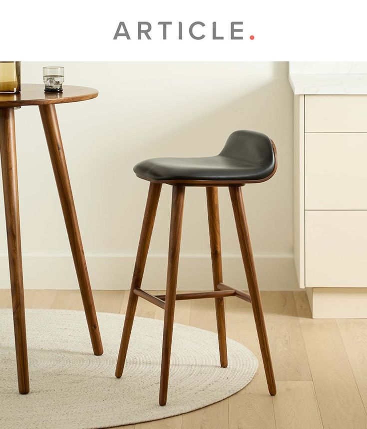 two stools sitting next to each other in front of a table