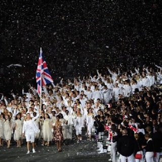 a large group of people standing in front of a flag