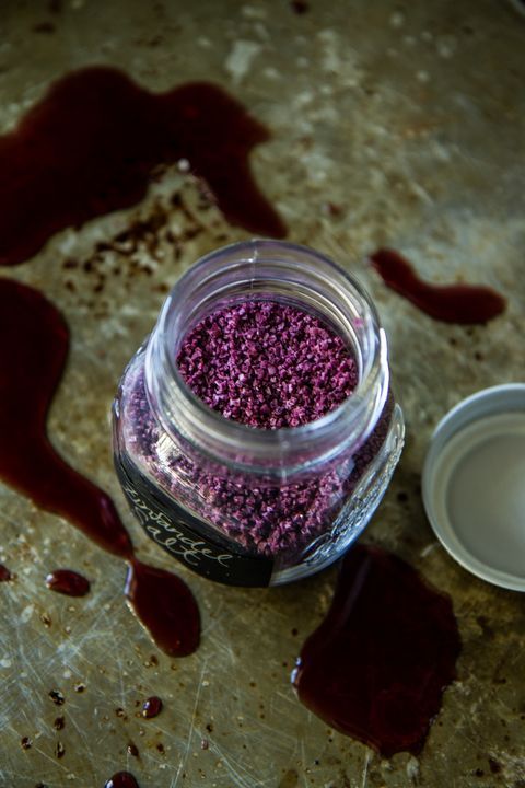 a jar filled with purple sprinkles next to a container of white powder