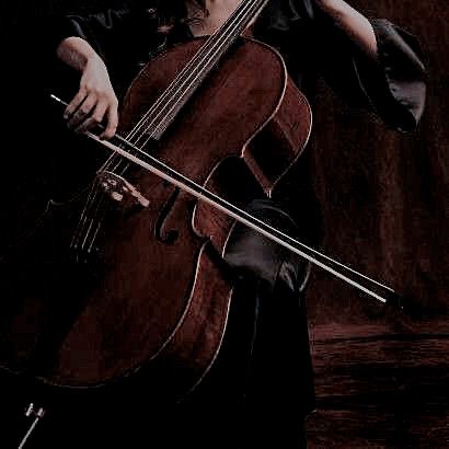 a woman holding a cello in her right hand