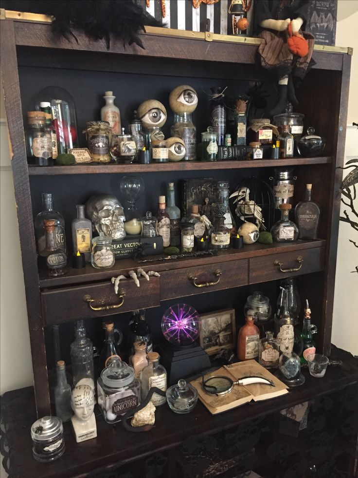 an old wooden shelf with lots of bottles on it