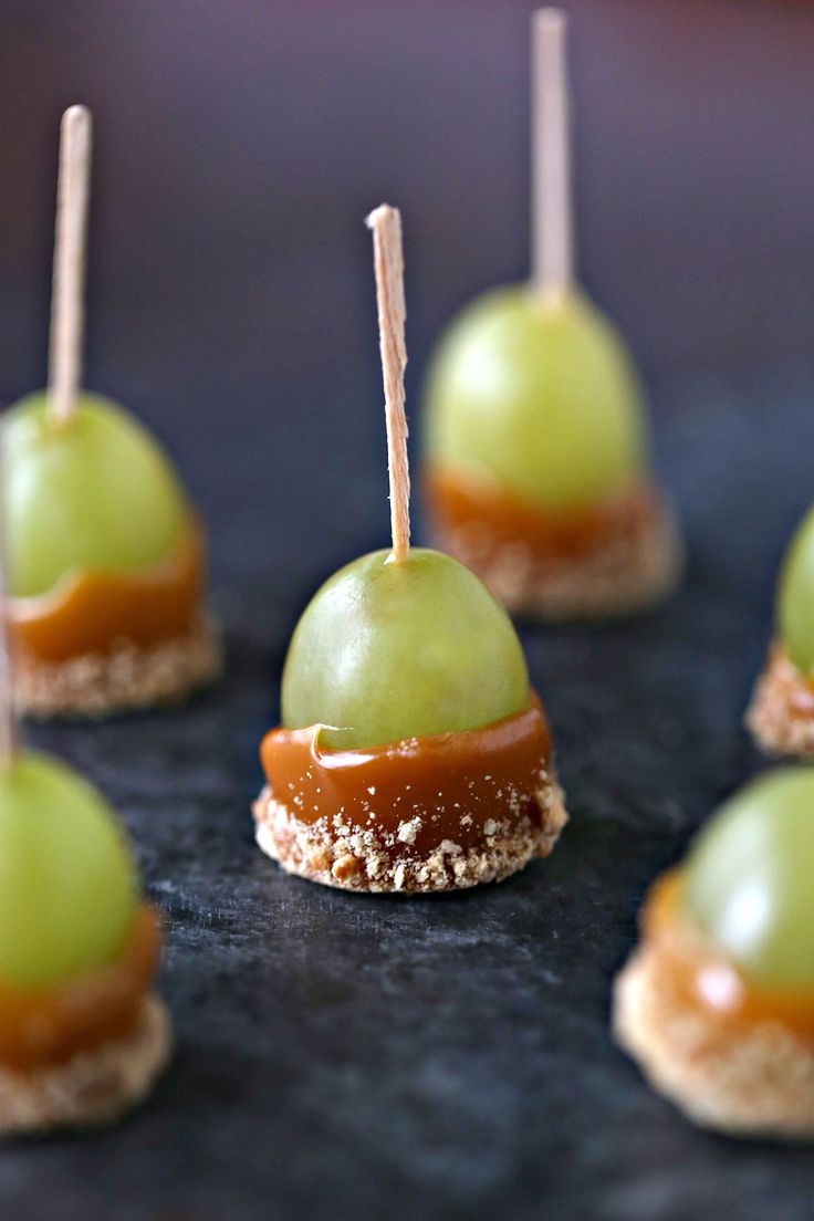 small desserts with green and brown toppings on sticks