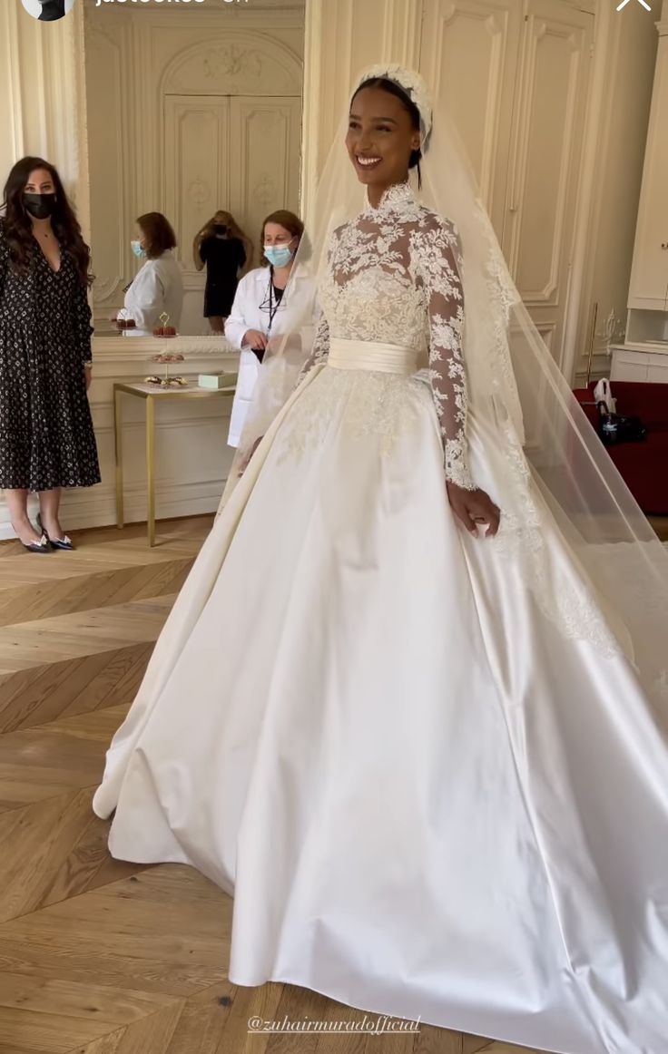 a woman in a white wedding dress and veil