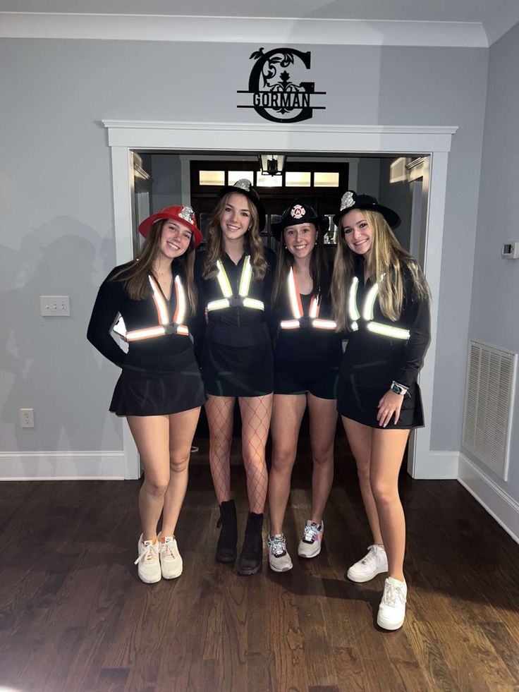 four girls in matching outfits posing for the camera